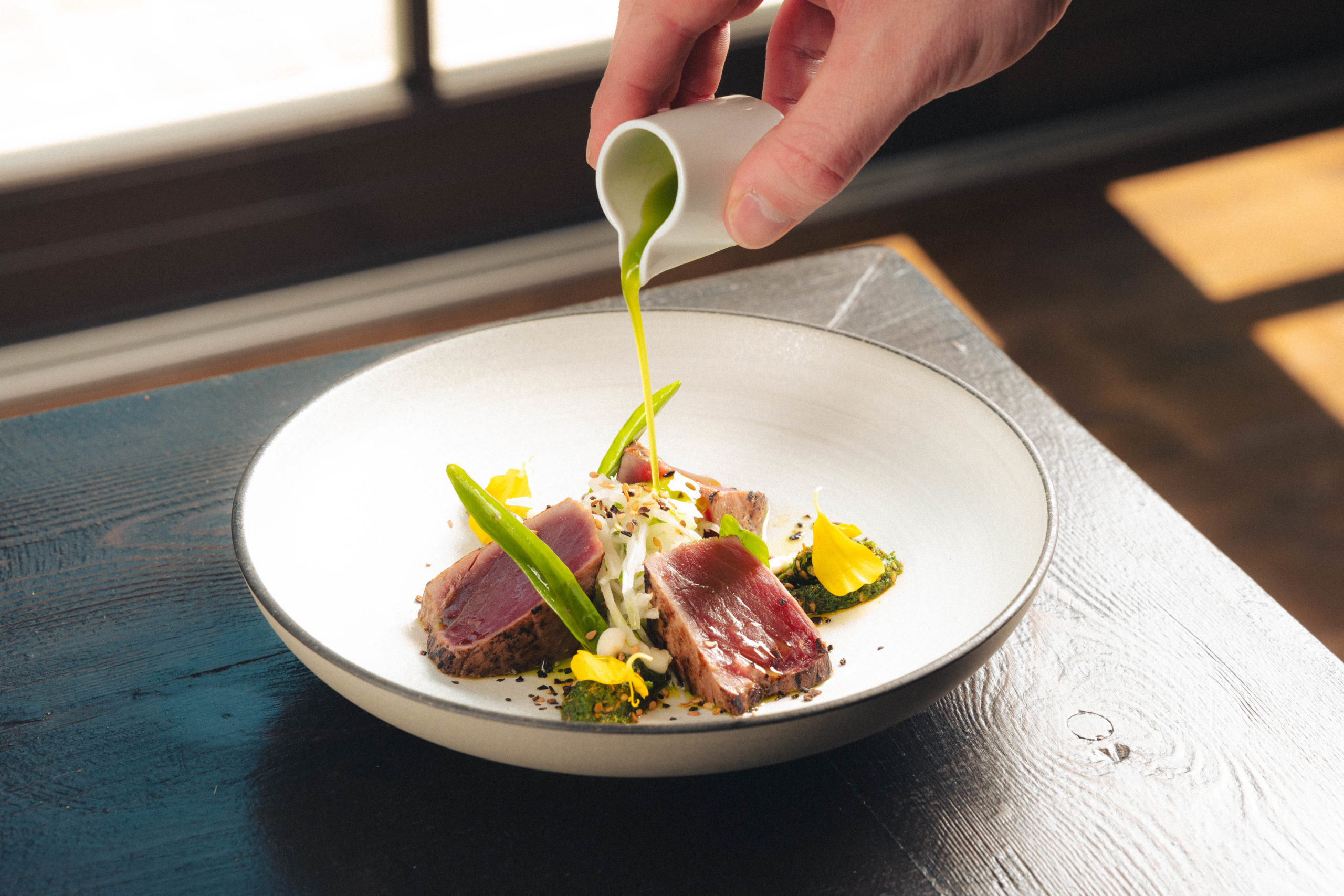 On the menu of the Restaurant Amitié, you will find a delicious tuna tataki with daikon radish, Jalapeño peppers and a Miso mayonnaise.